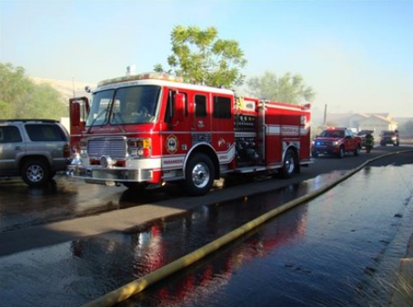 A line of fire emergency vehicles line the street
